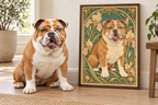 A real bulldog sits on a wood floor beside a framed art print showing an illustrated version of the same bulldog in an Art Nouveau floral design. The room has a window, plants, and a stool.