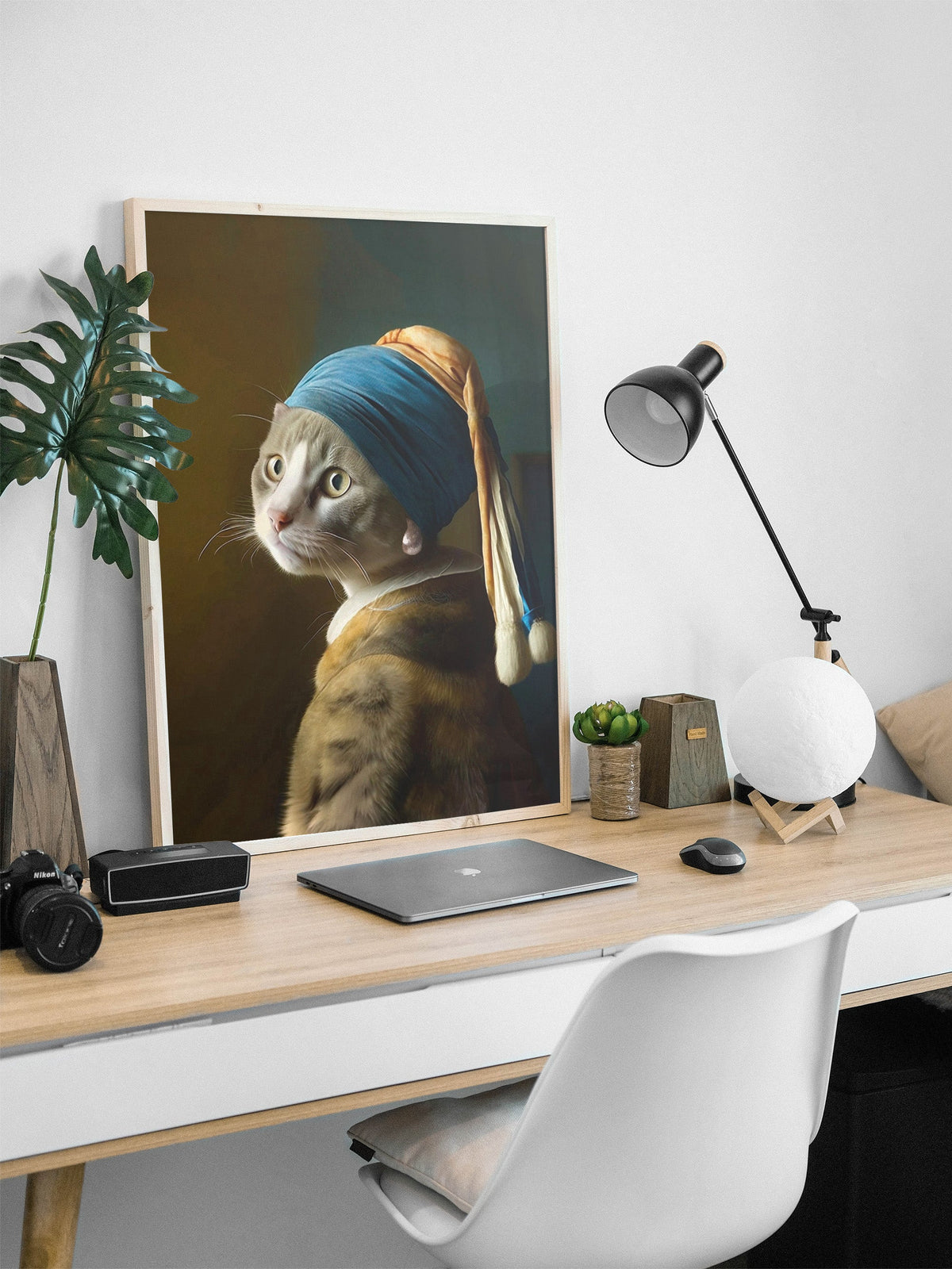 Pearl Earring Gray Cat framed above a desk