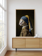 Pearl Earring Ginger Cat framed above a sideboard