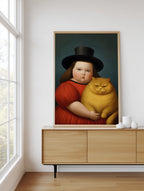 Girl & Her Unimpressed Ginger Cat framed above a sideboard
